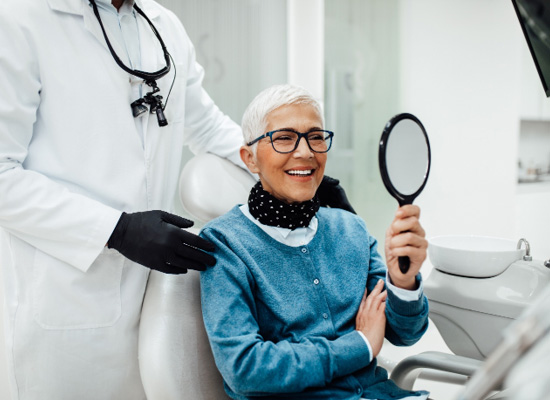 Senior woman smiling while looking at reflection