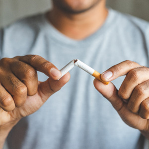 Closeup of patient breaking cigarette