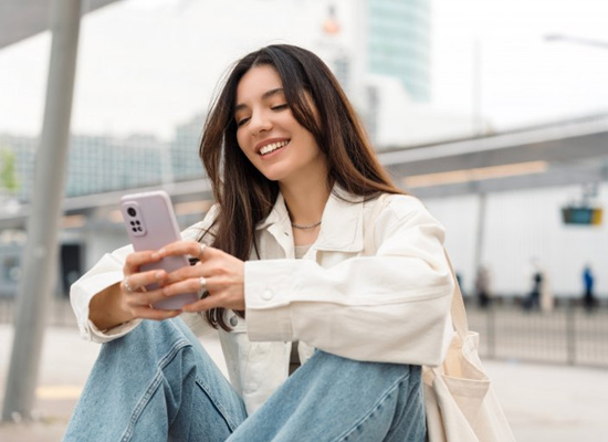 Lady smiles while reading about dental insurance