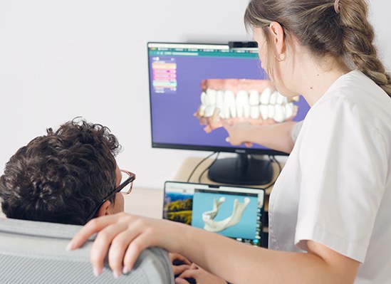 Dentist in Colorado Springs reviewing smile makeover treatment plan with patient 