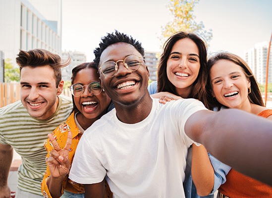 Colorado Springs veneer patient smiling with friends 