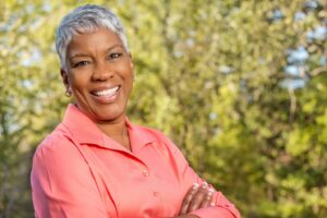 Woman with white teeth smiling.